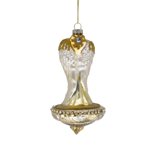 Back of a vintage-style glass Christmas ornament depicting the Angel with Mary and Baby Jesus, with a gold-toned base and a hanging loop at the top.