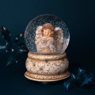 Musical snow globe with an angel figure 