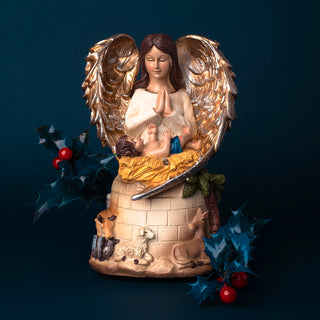 Christmas angel in orayer with baby jesus musical carillon in resin