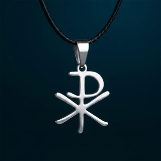 A silver pendant necklace featuring a Chi-Rho symbol hanging from a black cord, set against a dark teal background.