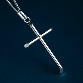 Classic Cross Pendant, shown against a dark navy blue background.