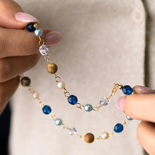 close up of a Rosary with multicolored beads and gold accents 