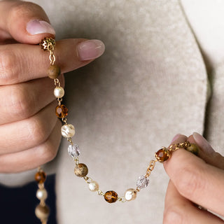 Saint Benedict Rosary in golden metal
 with brown, white, and gold crystals and stones beads