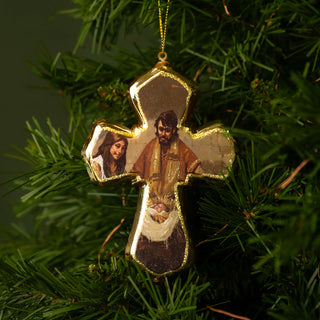 Decorative Christmas ornament with religious figures on a green tree