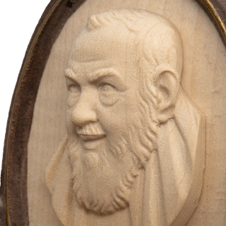 Detail of St Pio of Pietrelcina holy water font for home in natural carved wood