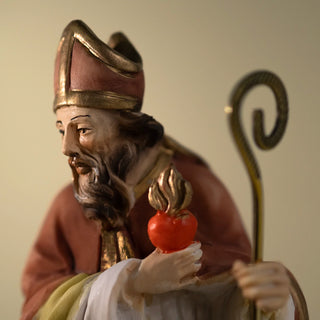 A close-up of a St Augustine Resin Statue