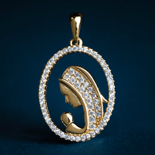 St Mary pendant in gold-plated sterling silver with zirconia, showcasing elegant openwork design. againt a dark blue background