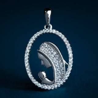 St Mary pendant in sterling silver with white zirconia, featuring an openwork design of St Mary and Baby Jesus photograph in a blu background