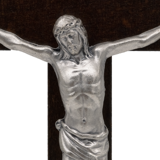 Silver-toned metal crucifix corpus featuring a detailed sculpture of Jesus Christ with outstretched arms, mounted on a dark wood cross
