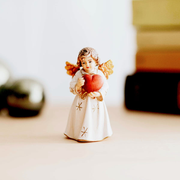 wooden angel statue with heart