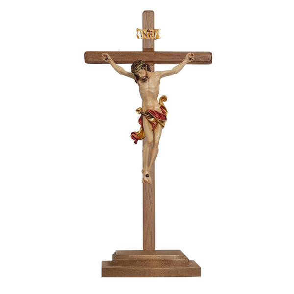 Red drape crucifix in carved wood